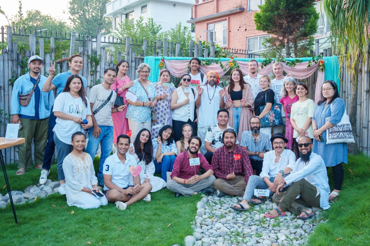 A group of participants smiling together in a garden